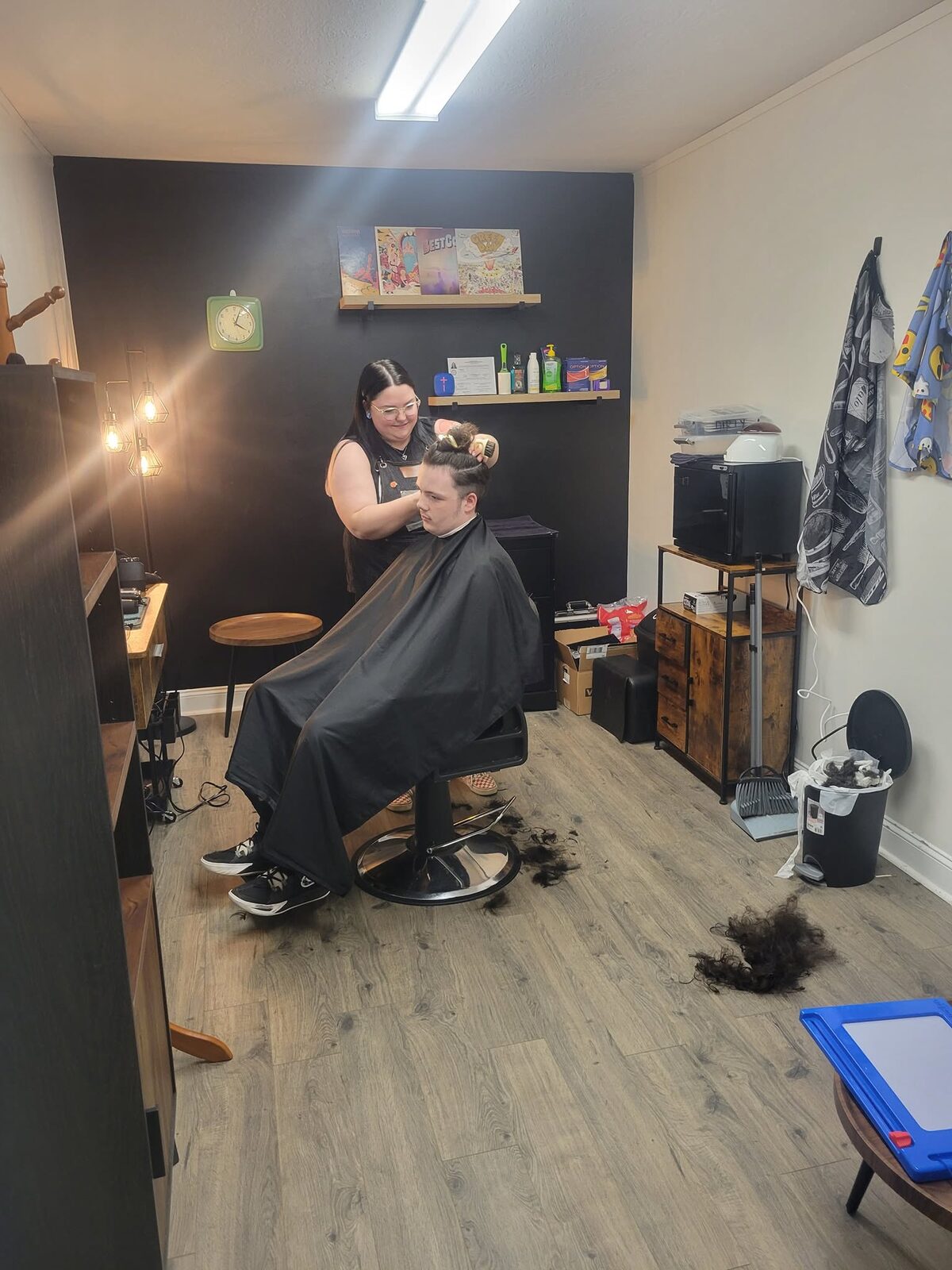 Barber styling a client in the barber studio