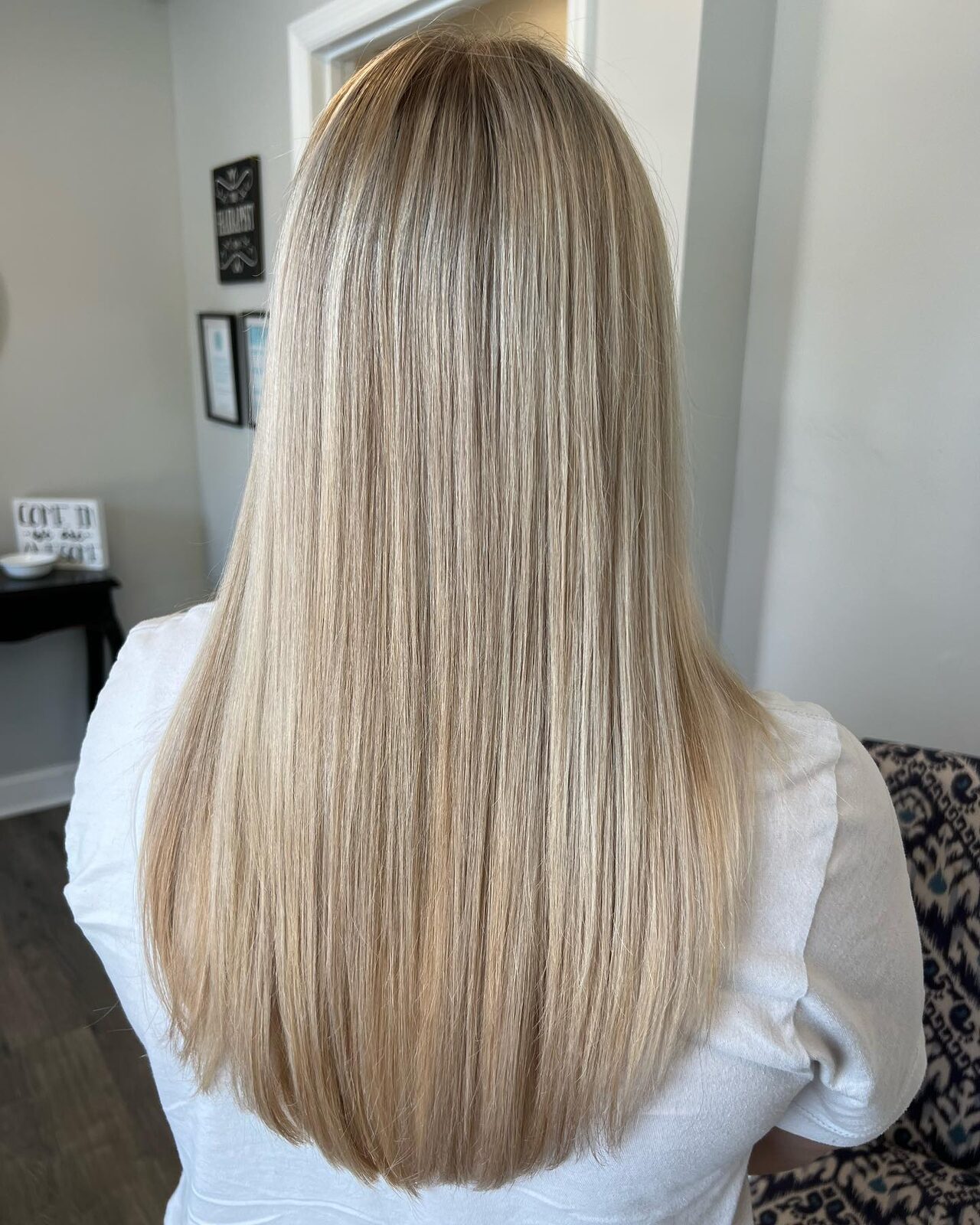 Sleek bright blonde with soft highlights by Natalie Marie