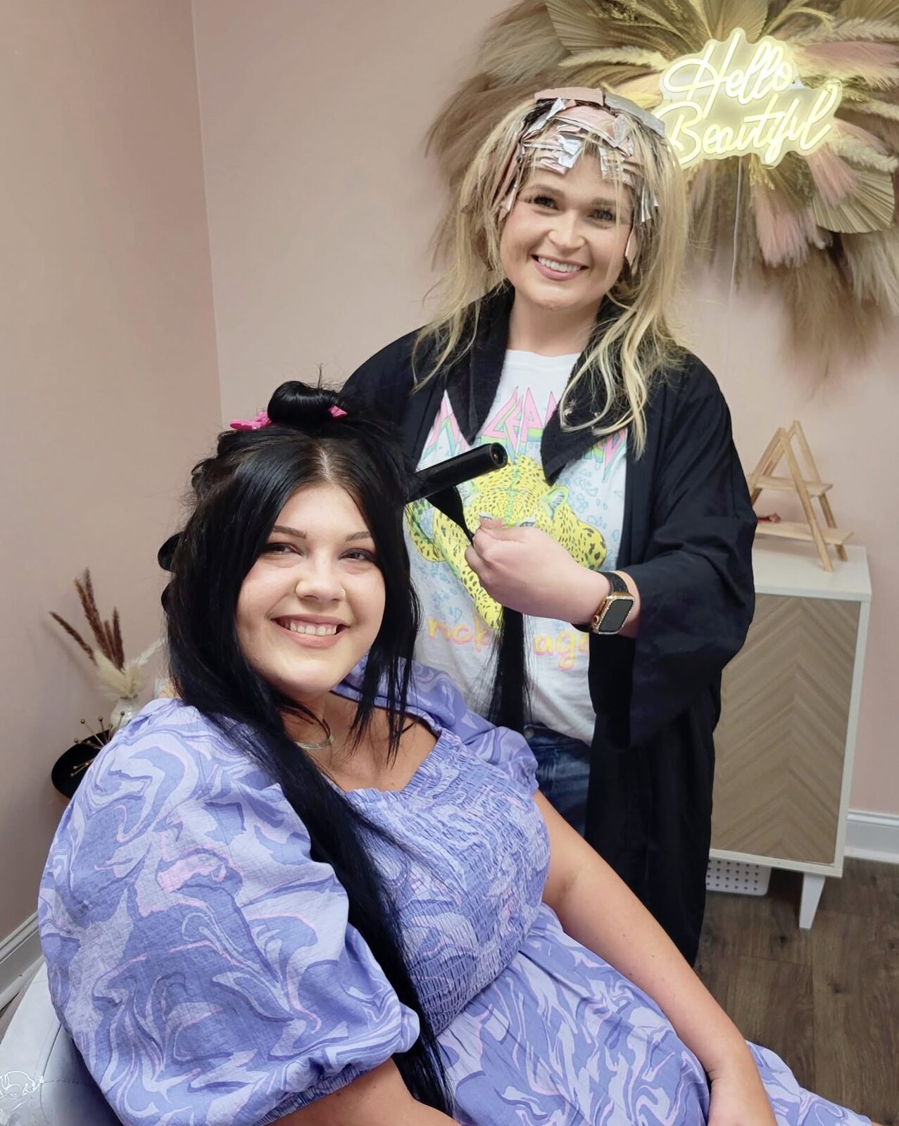 Stylist curling a client's hair in the salon