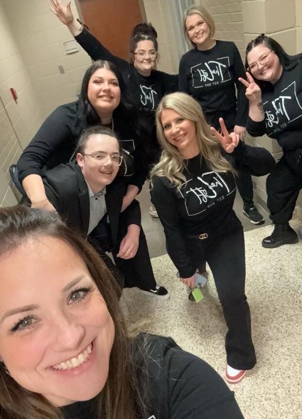 The Loft team of seven in matching black Loft shirts